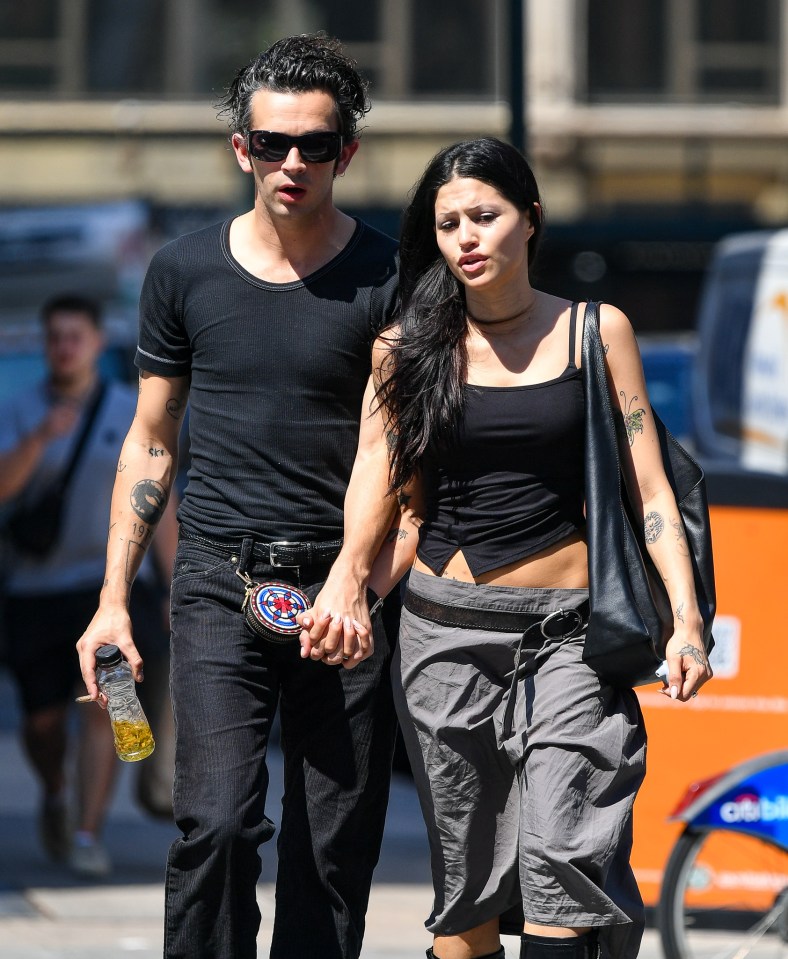 Matt Healy and Gabbriette Bechtel holding hands in New York City.
