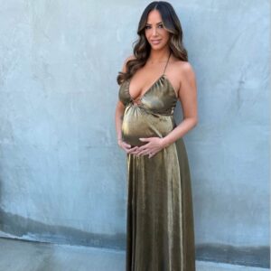 Pregnant Kristen Doute in a gold dress.