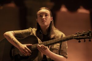 A still photo of Bella Ramsey in the HBO series The Last of Us.