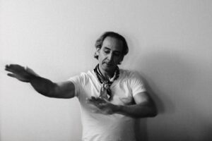 A conductor makes a shape with his hands.