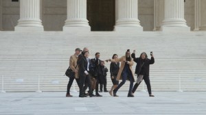 ACLU attorney Chase Strangio (left, in suit and tie) joins a group on the steps of the U.S. Supreme Court in Washington, D.C.