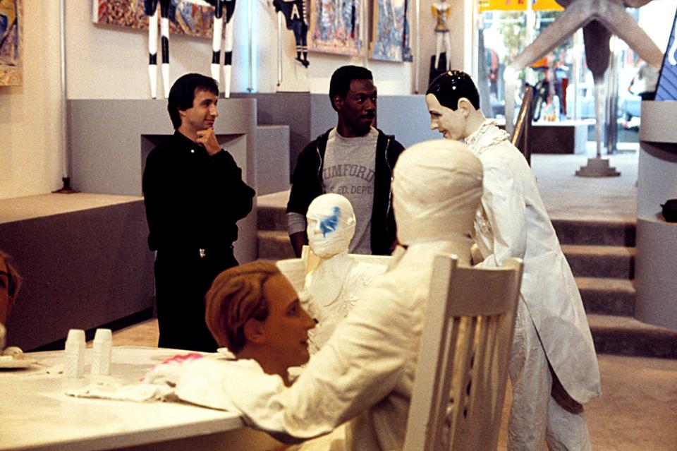 Behind-the-scenes photo of Bronson Pinchot and Eddie Murphy filming *Beverly Hills Cop*.