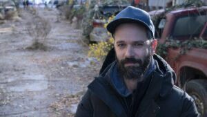 Neil Druckmann in a baseball hat on the set of The Last of Us