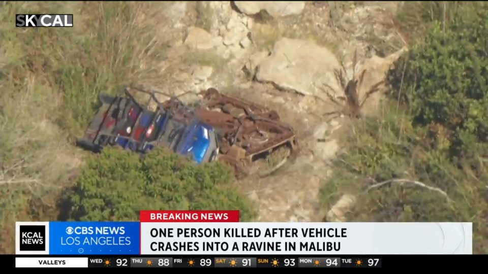 Aerial view of a wrecked vehicle in a ravine.