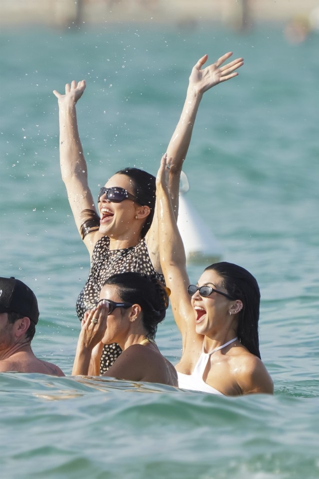 Kylie and Kendall Jenner playfully splashing in the ocean.