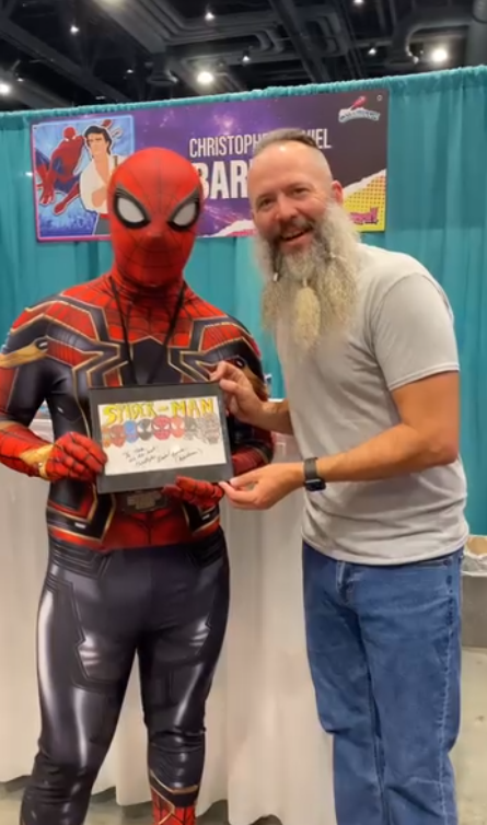 Person in Spider-Man costume receiving an award.