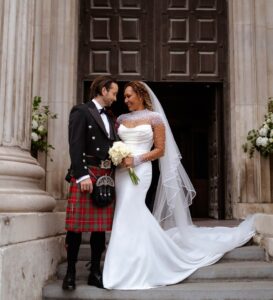 Wedding couple posing on steps.