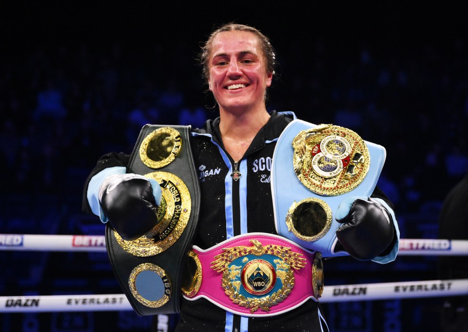 Ellie Scotney celebrates her boxing victory with championship belts.