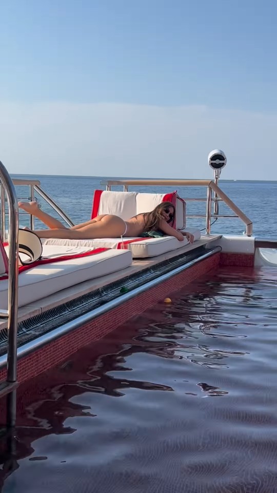 Sofia Vergara sunbathing in a tiny bikini on a yacht by the pool.