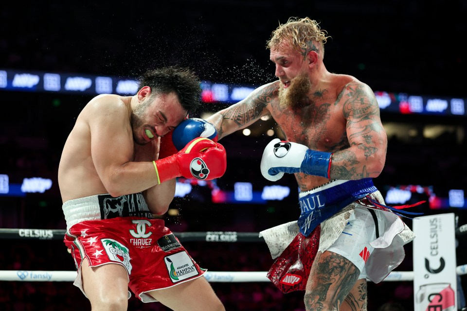 Jake Paul landing a punch on Julio Cesar Chavez Jr. during a boxing match.