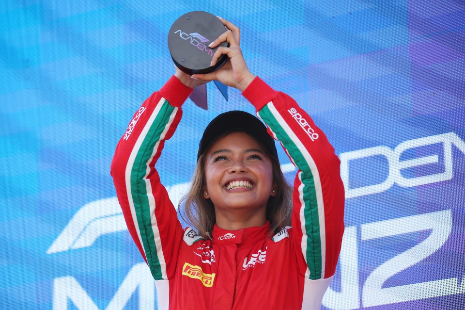 Bianca Bustamante, F1 Academy race winner, holding a trophy.