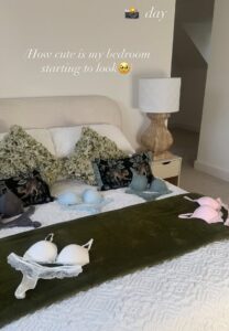 Bedroom with lingerie displayed on the bed.