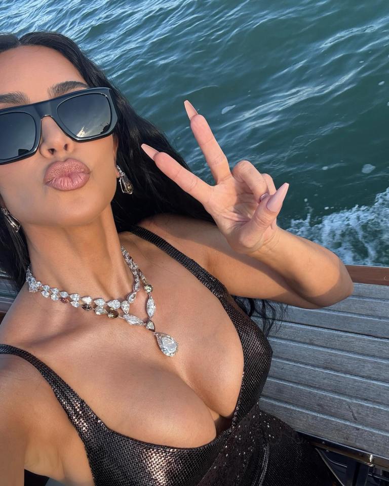 Kim Kardashian in Venice, giving a peace sign.
