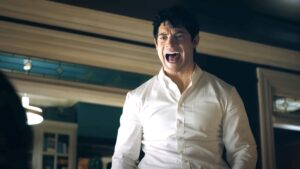 Clark Kent in a white dress shirt yelling in Superman
