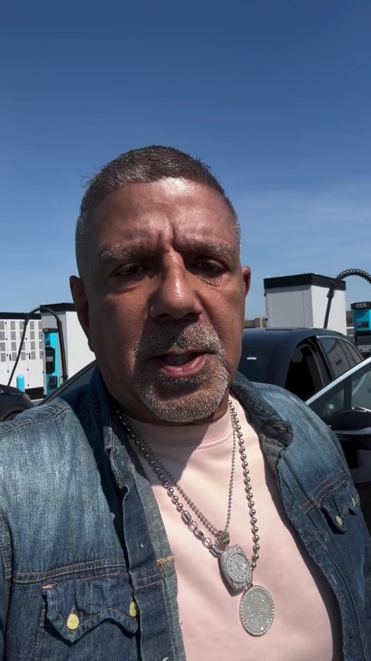 Ray De Jon speaking in front of electric vehicle charging stations.