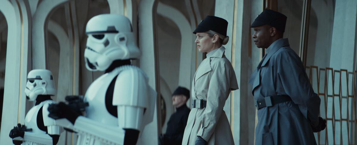 two Stormtroopers and two uniformed officers