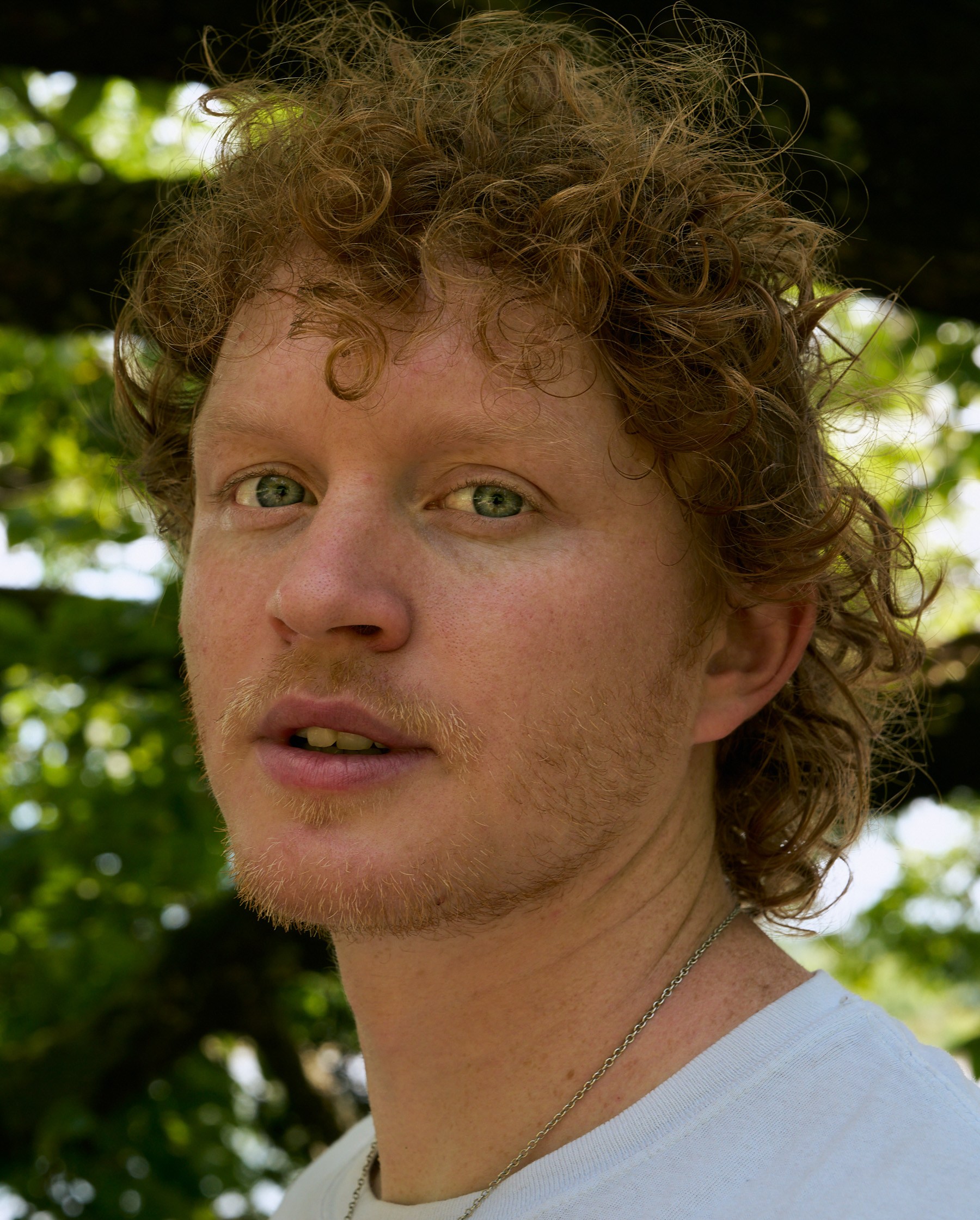 Close portrait of Knox Morris looking straight into camera at Shelby Park in Nashville, TN.