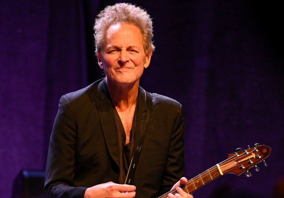 Lindsey Buckingham performing at a concert.