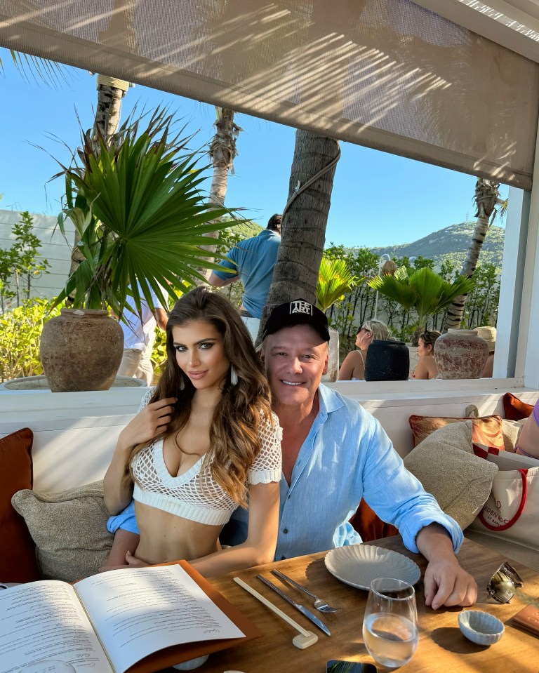Lisa Hochstein and a man dining outdoors.