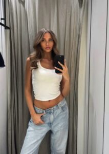 Woman taking a selfie in a changing room.
