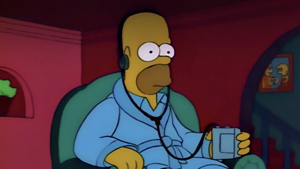Homer in a bathrobe with headphones in at night on The Simpsons