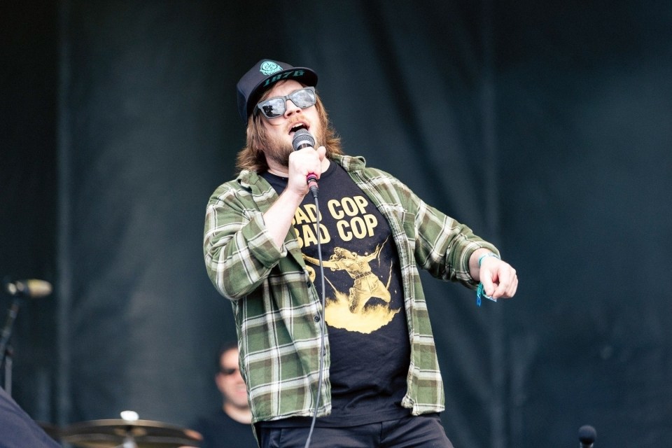 Justin Pierre of Motion City Soundtrack performing on stage.