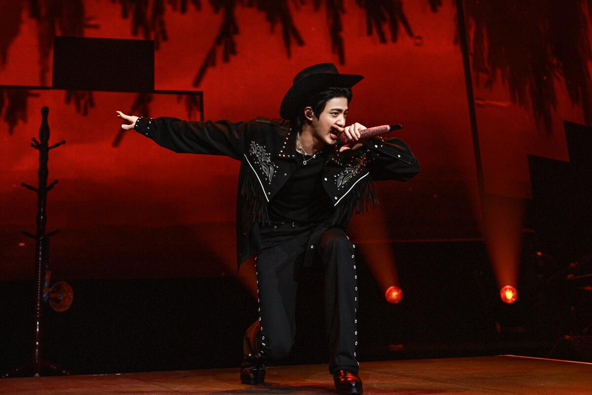 Jin changes into a country-western look during the song "Rope It" at the Honda Center