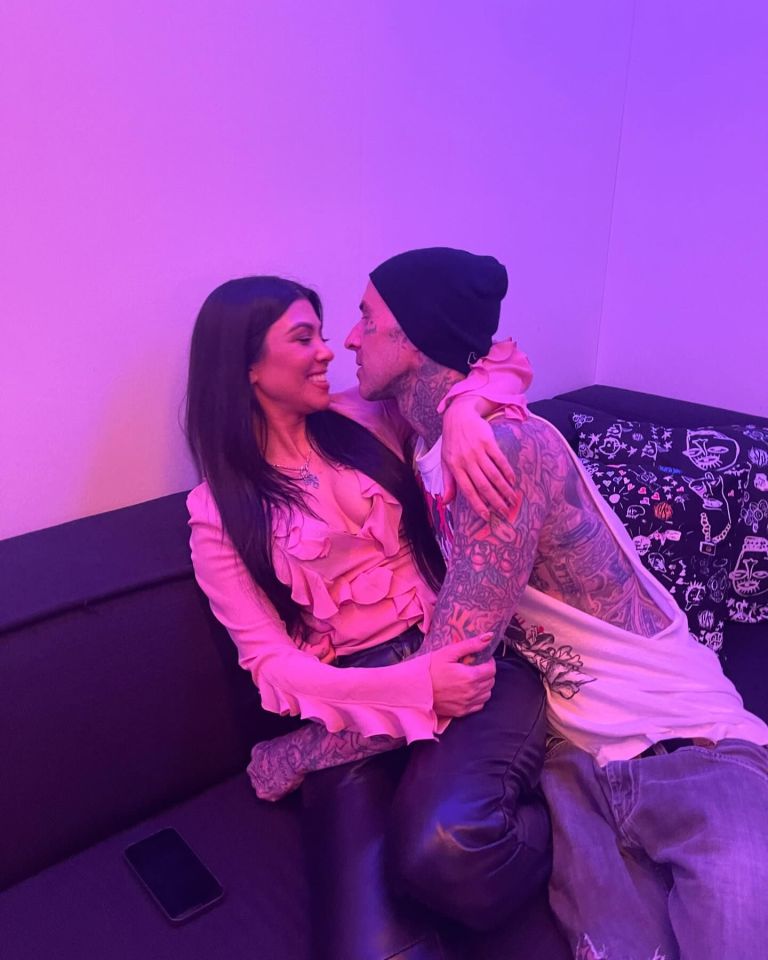 Kourtney Kardashian and Travis Barker embracing.