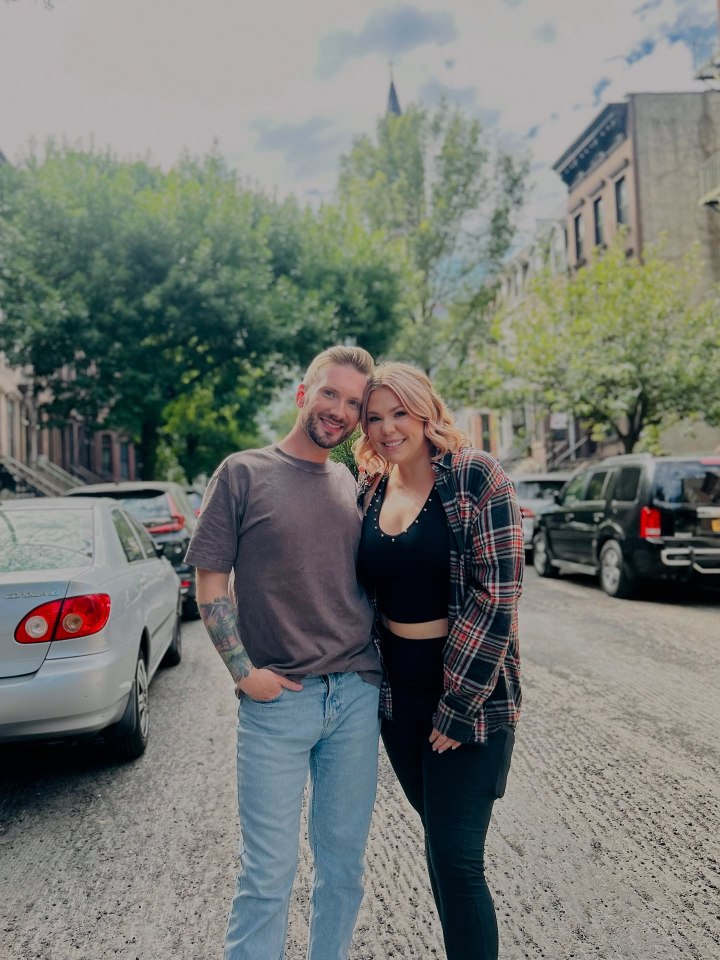 Couple posing on city street.