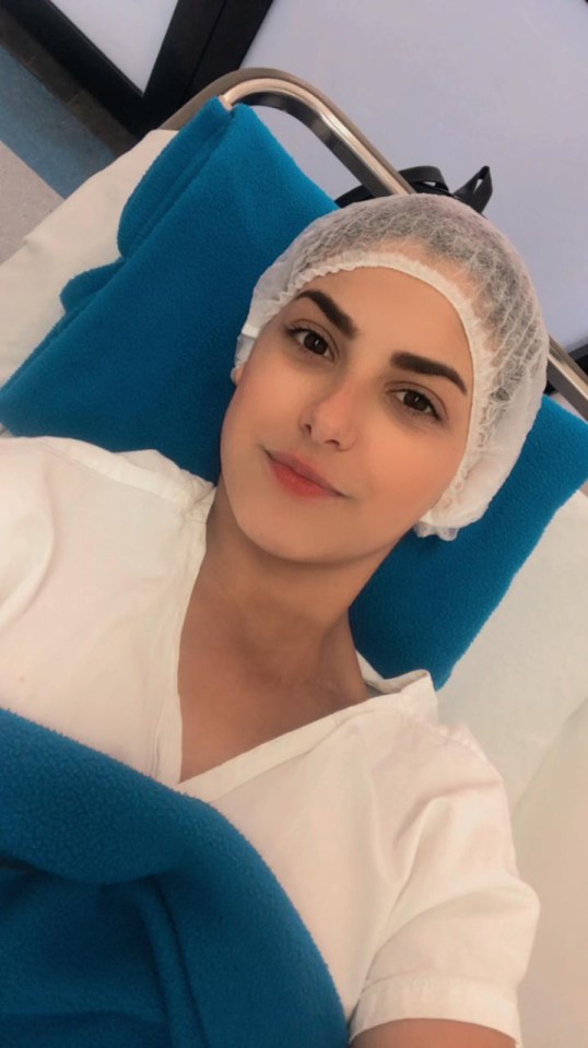 Woman in hospital gown and cap.