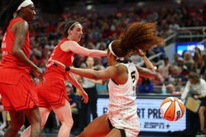 Angel Reese #5 of the Chicago Sky takes a hard foul from Caitlin Clark #22 of the Indiana Fever in the second half during the Fever's home opener at Gainbridge Fieldhouse on May 17, 2025 in Indianapolis, Indiana.