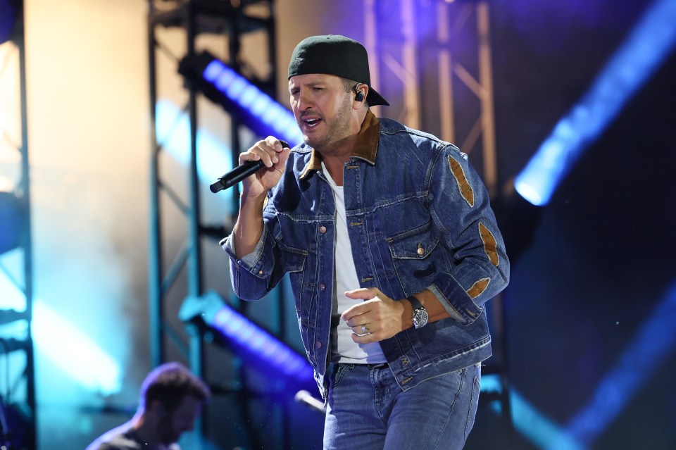 Luke Bryan performing at a concert.