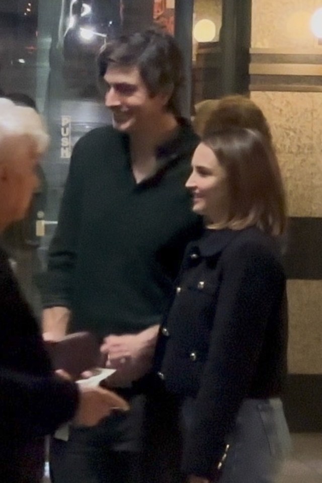 Brandon Routh and Rachael Leigh Cook holding hands.
