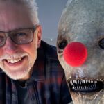 James Gunn with Mr. Handsome, an alien-like creature, wearing a red clown nose