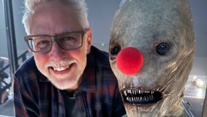 James Gunn with Mr. Handsome, an alien-like creature, wearing a red clown nose
