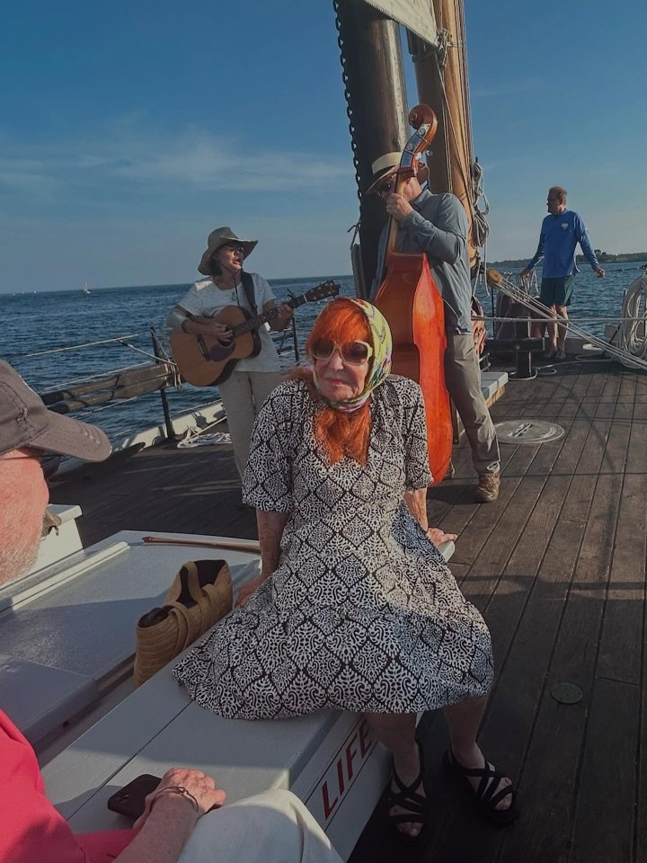 Sally Jessy Raphael on a sailboat with musicians.