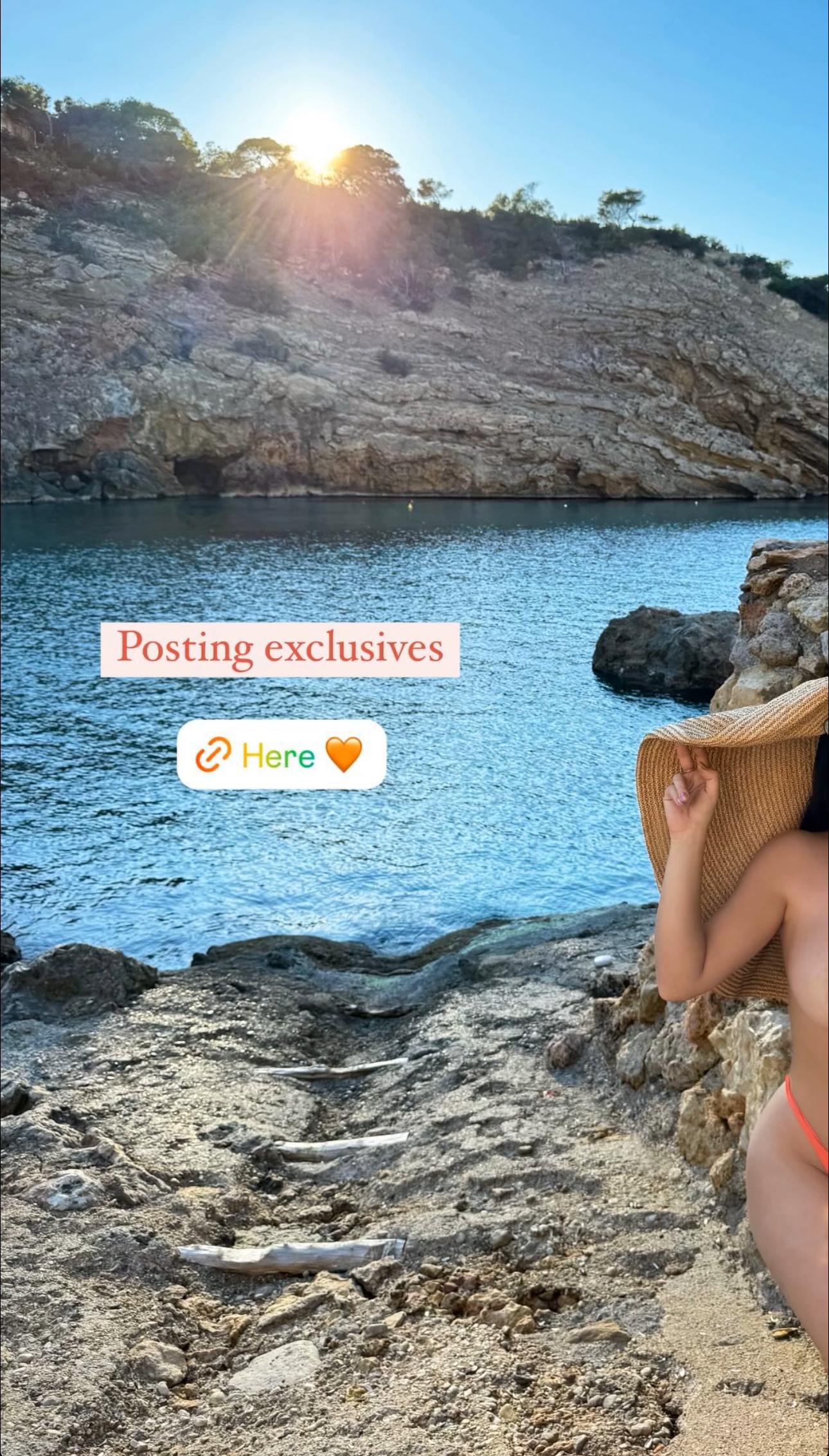Demi Rose poses at the beach in nothing but her bikini bottoms.