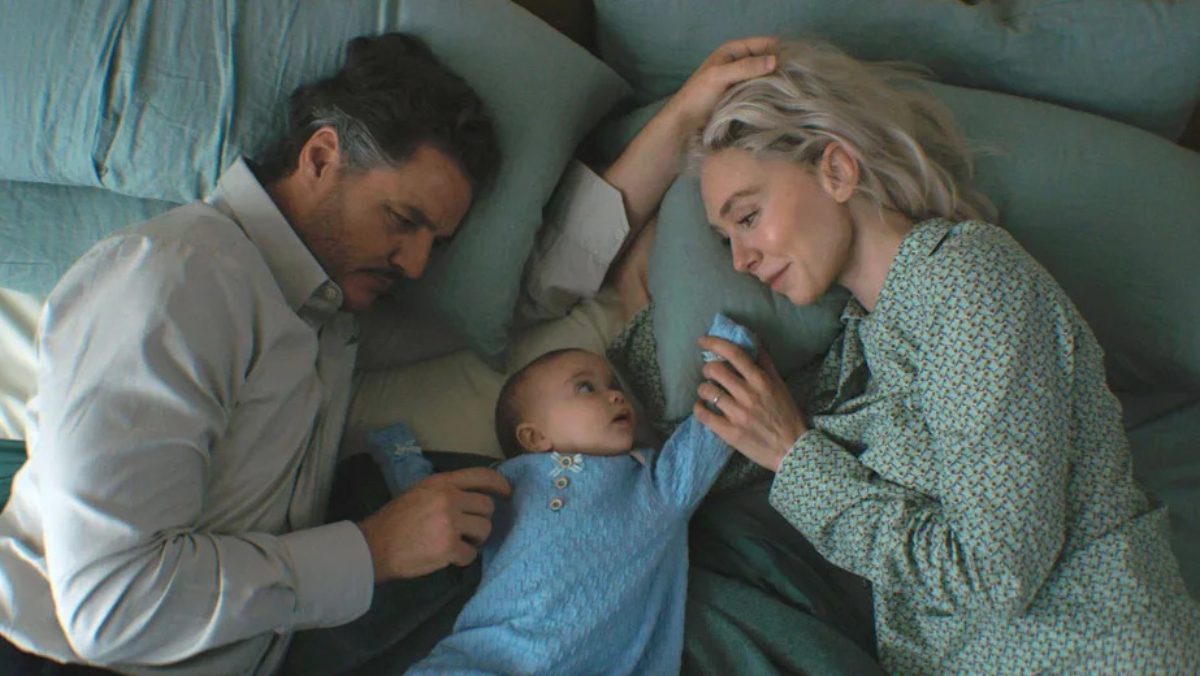 Reed Richards (Pedro Pascal) and Sue Storm (Vanessa Kirby) lying in bed with their newborn son Franklin in The Fantastic Four: First Steps