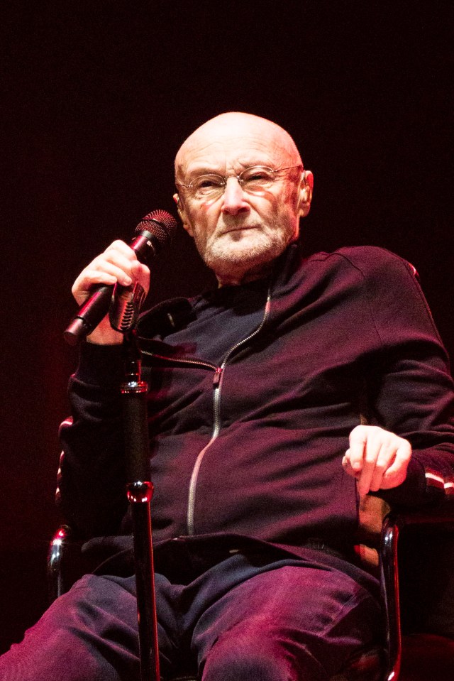Phil Collins holding a microphone.