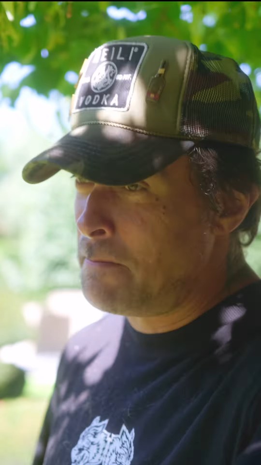 Close-up of Jason Momoa without a beard, wearing a baseball cap.