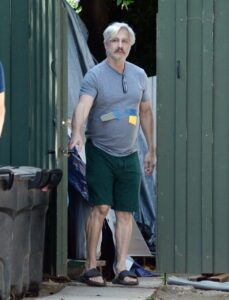 Bronson Pinchot leaving a building.