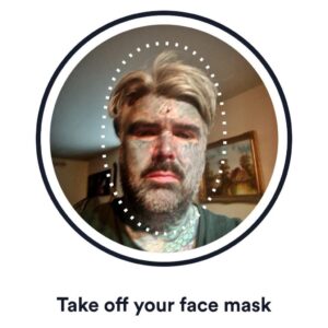 tattooed man told to remove face mask