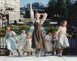 Still from *The Sound of Music* showing Maria and the children running.