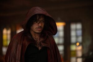 Anthony Ramos as Peter Robinson, standing in a red hood from Marvel’s Ironheart series