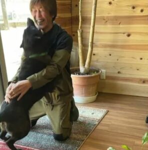 Saito embraces a dog at his rescue.