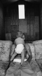 Black and white photo of Justin Bieber holding his baby.