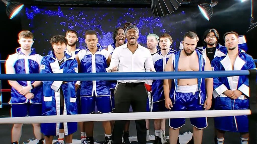 KSI stands with ten of his fans in a boxing ring.