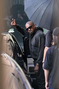 Kanye West waving from a car.