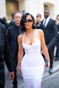 Kim Kardashian in a white dress at a fashion show in Paris.