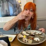 Sally Jessy Raphael eating oysters.
